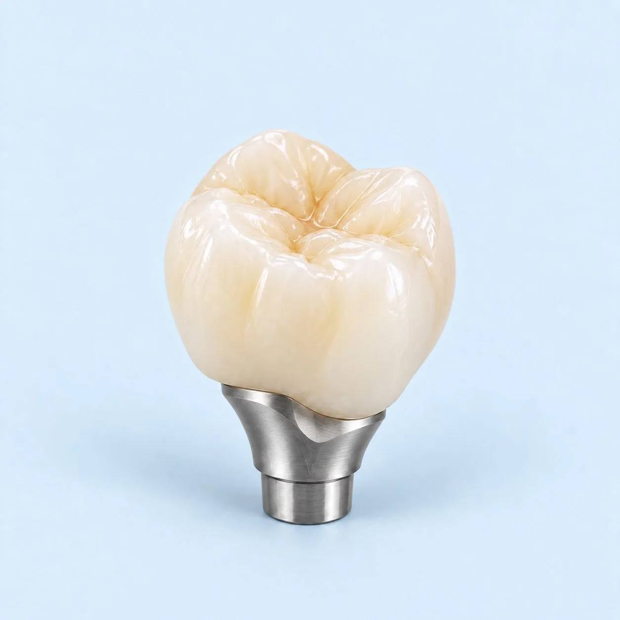 A zirconia crown on its metal abutment, photographed from the side against a plain ground